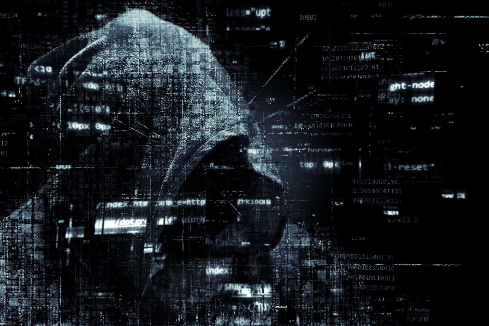 A shadowy, hooded figure is silhouetted against a backdrop of scrolling computer code and digital noise, symbolizing cybercrime, hacking, and data security threats.